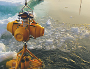 Deploying a mooring carrying a suite of monitoring sensors into the sea ice.