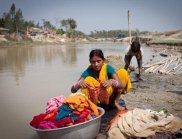 Woman washing clothes next to river (Image: Nabin Baral, ICIMOD)