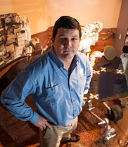 Paulo de Souza pictured with a model of the Opportunity Rover at Canberra Deep Space Communication Complex.