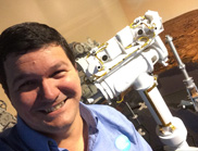 Paulo de Souza in front of a model of the Mars Rover, Opportunity.