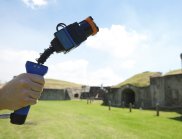 A hand holding the Zebedee, a handheld laser scanner 