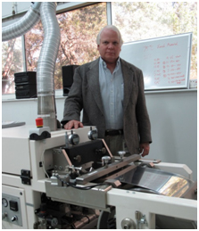 Richard Donelson standing behind machinery