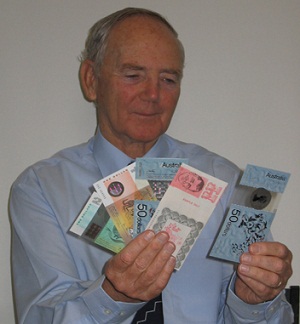 Dave Solomon holding a handful of various banknotes