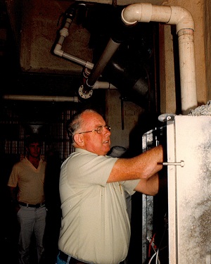 Dr Bob Winks making adjustments in the SIROFLO control cabinet at Wallendbeen