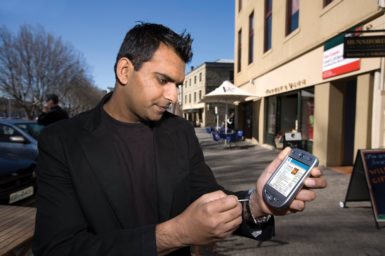 Mr Dipak Bhandari, with a handheld digital device