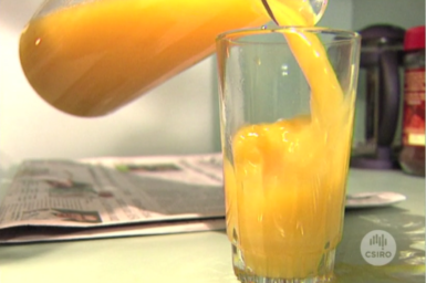 Glass of orange juice being poured