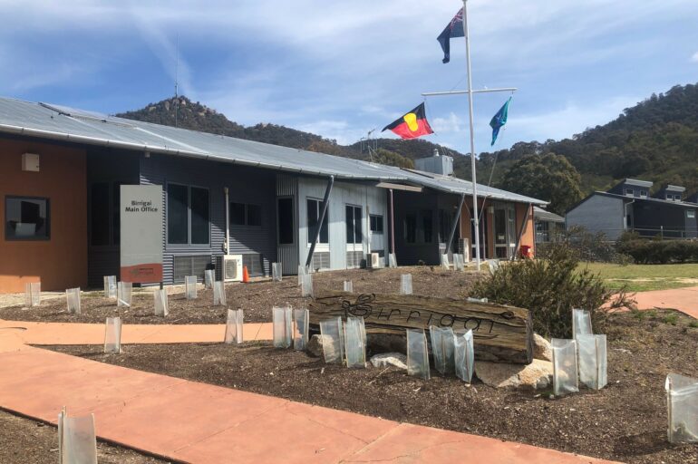 Birrigai Outdoor School building with Australian Aboriginal flag, Australian flag and Torres Strait Islander flag flying out the front.